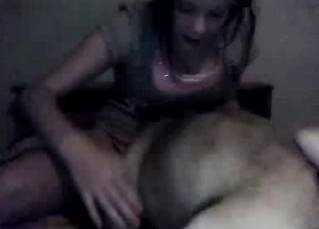 Dark-haired teen getting licked by a dog