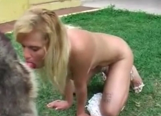 Blonde beauty gives a blowjob for a nice dog